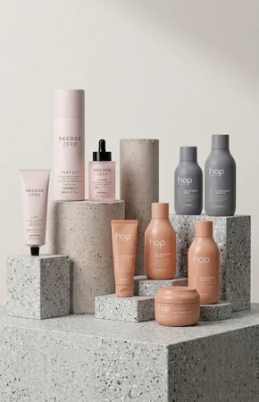 Haircare bottles and jars arranged on concrete plinths